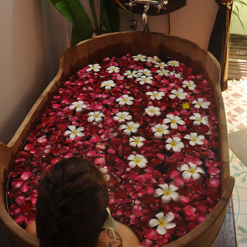 Siam Botanicals Relaxing Bath Salts in Wooden Bath with Flowers
